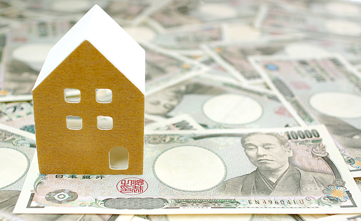 お金と白い家の模型